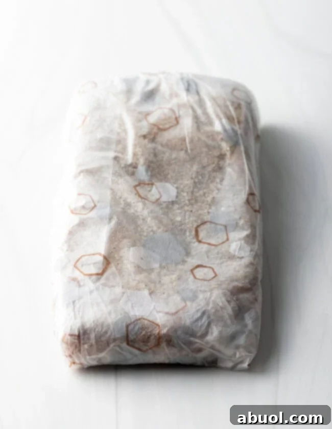 Salted meat wrapped tightly in plastic wrap.