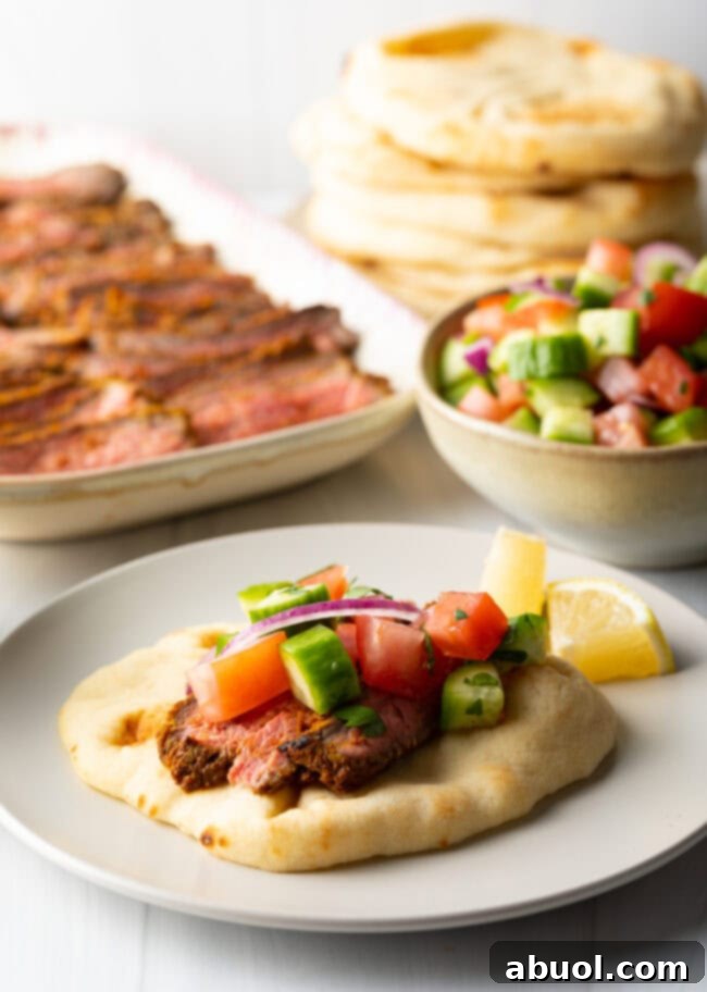 Savory Spiced Beef Shawarma 12 Beef shawarma recipe on naan, topped with chopped cucumbers and tomatoes.