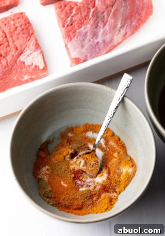 Savory Spiced Beef Shawarma 7 Bowl with blend of spices and metal spoon.