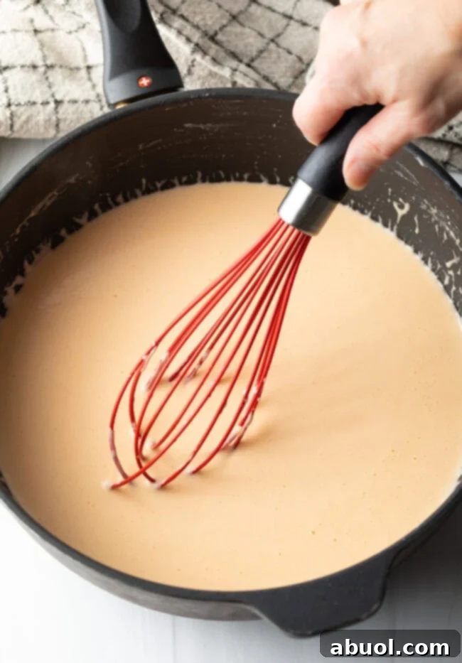 Garlic powder shaker, adding savory depth to the cheese sauce.