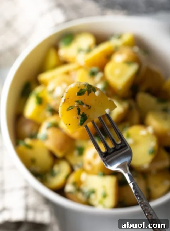 Fork with potato, showing to camera.