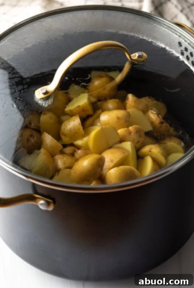 Covered cooking pot, steaming baby potatoes.