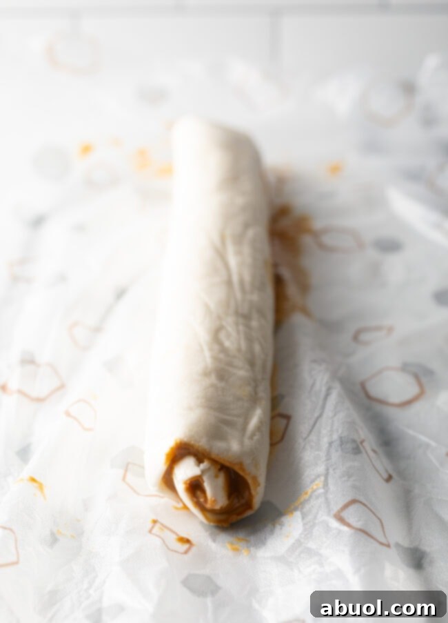 Round log of rolled mashed potato candy and peanut butter.