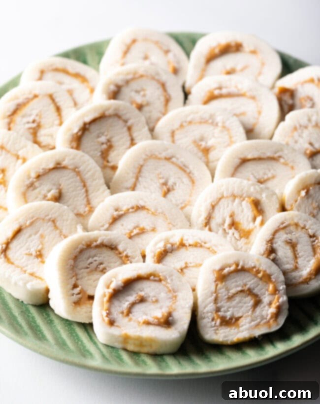 Green plate filled with round peanut butter potato candy slices.