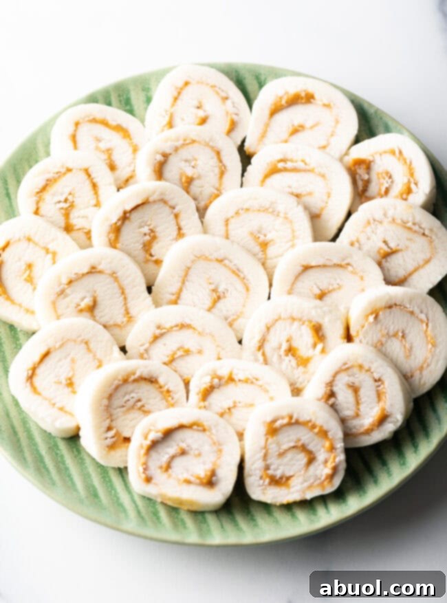Green plate filled with round peanut butter potato candy slices.