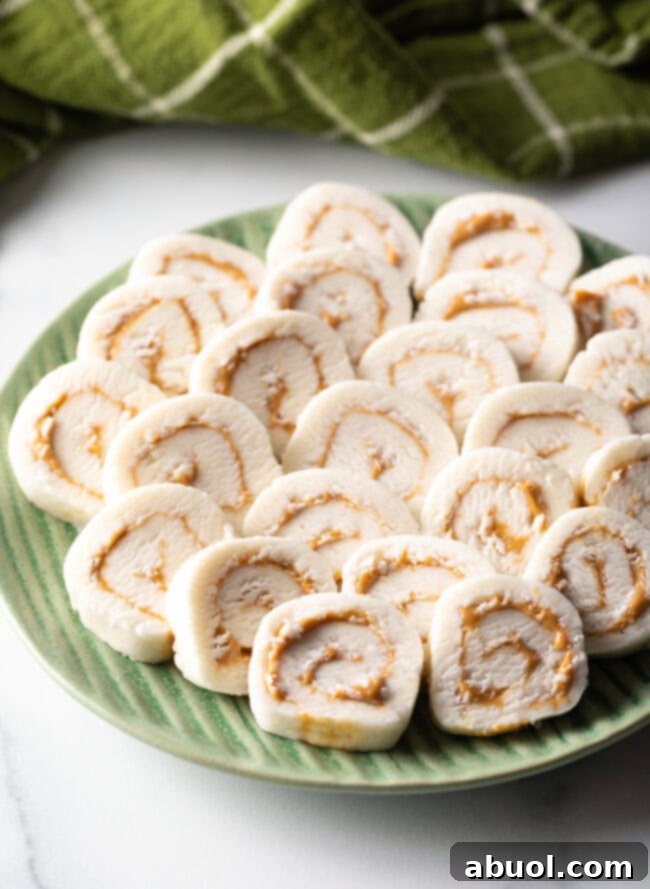 Green plate filled with round potato peanut butter candy slices.