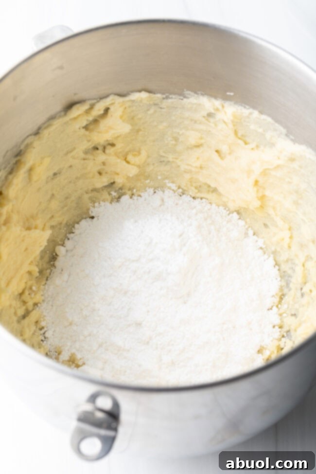 Mixing bowl with mashed potatoes and powdered sugar.