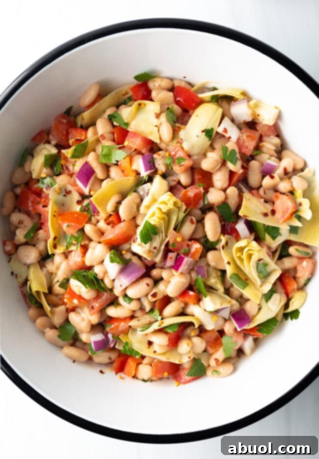 Vibrant Artichoke White Bean Delight 3 Top down view of all salad ingredients combined in a bowl, ready to be tossed with dressing.