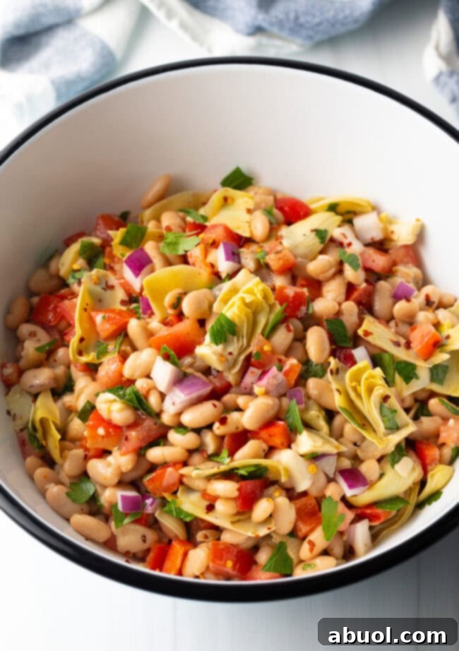 Vibrant Artichoke White Bean Delight 8 Top down view of all salad ingredients combined in a bowl, perfectly tossed and ready for serving.