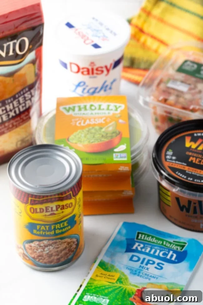 Recipe ingredients: can of beans, guacamole, shredded cheese, salsa, sour cream, ranch seasoning packet.