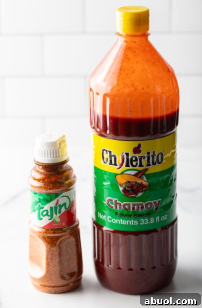 Bottle of chamoy and smaller bottle of Tajin seasoning.