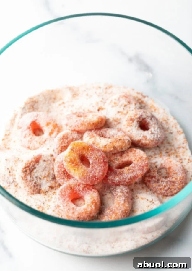 Close view of pile of Mexican chamoy candy gummy rings coated in sugar.