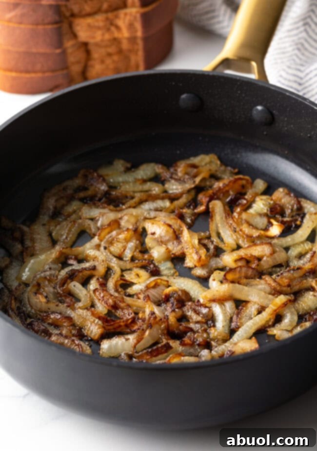 Caramelized onions in a skillet, deeply golden brown and tender.