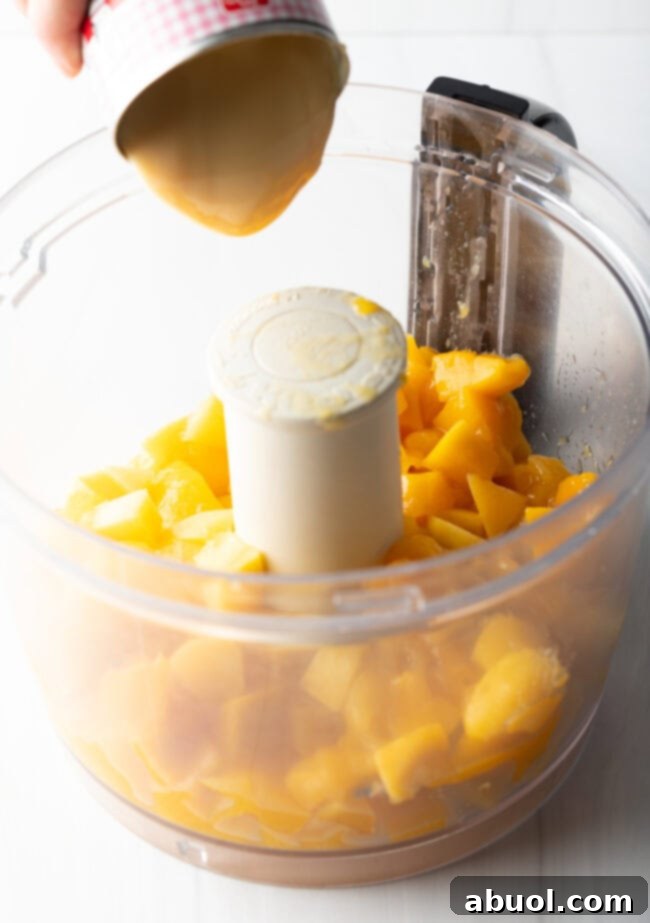 Mango chunks in a food processor.