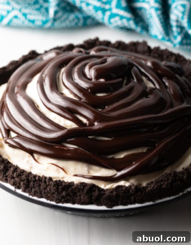 The Hula Pie fully assembled with the ice cream and fudge layers, topped with macadamia nuts, chilling in the freezer.