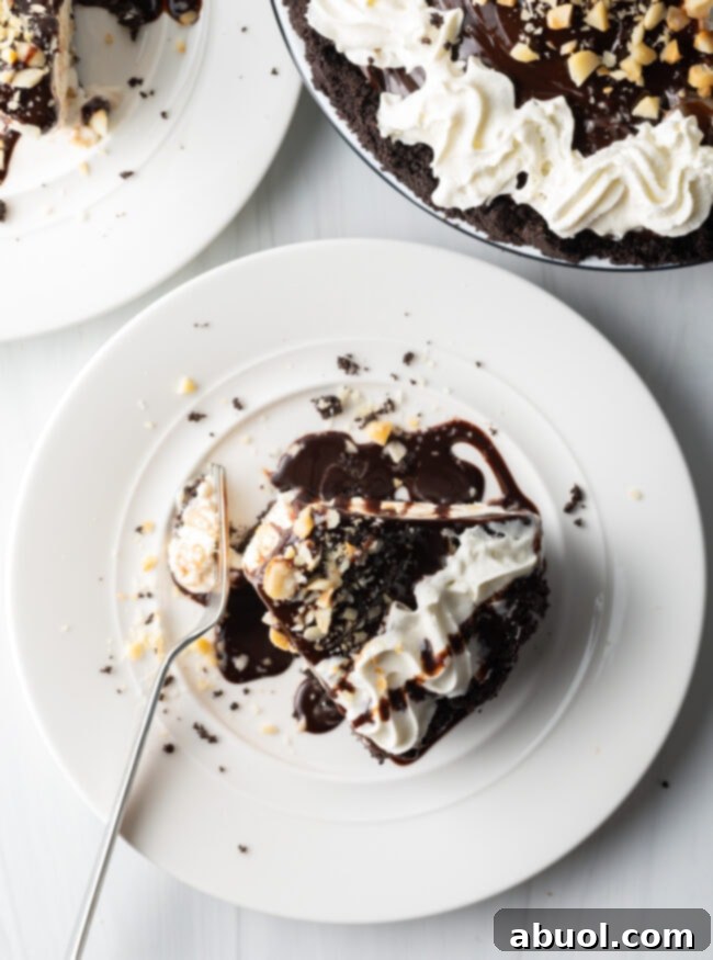 Top-down view of a delicious slice of Duke's Hula Pie, elegantly presented on a white plate with a fork.