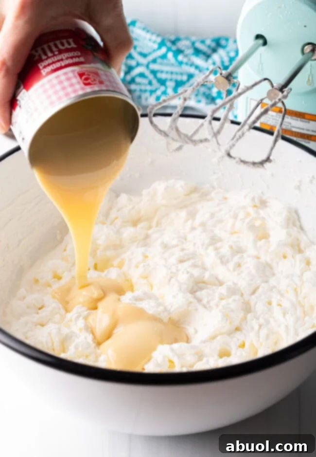 Oreo cookie crust mixture being pressed into a pie pan with the bottom of a glass.
