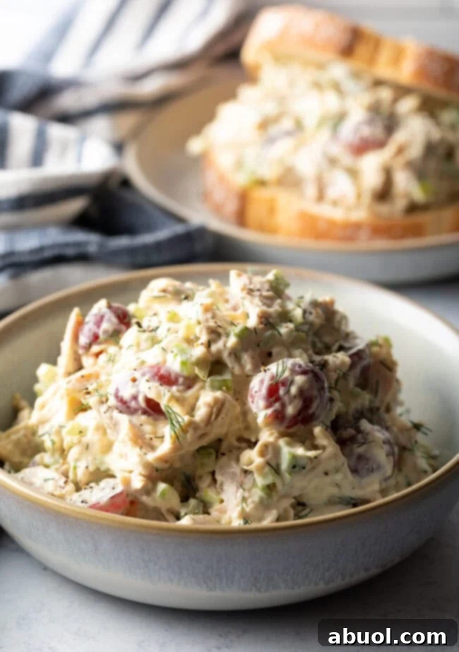 White bowl loaded up with turkey salad. Main shot of leftover turkey recipe post.