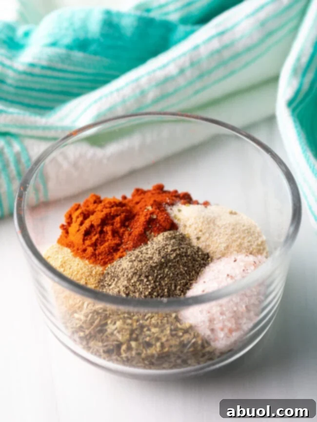 Individual blackening seasonings artfully arranged in a glass dish, poised for combination into a perfect blend.
