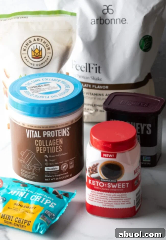 Power & Glow Collagen Brownies 5 Recipe ingredients laid out: almond flour, erythritol sweetener, unsweetened cocoa powder, collagen peptides, and sugar-free chocolate chips.