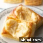 Two large Starbucks style cream cheese danishes on a white plate, perfect for printing.