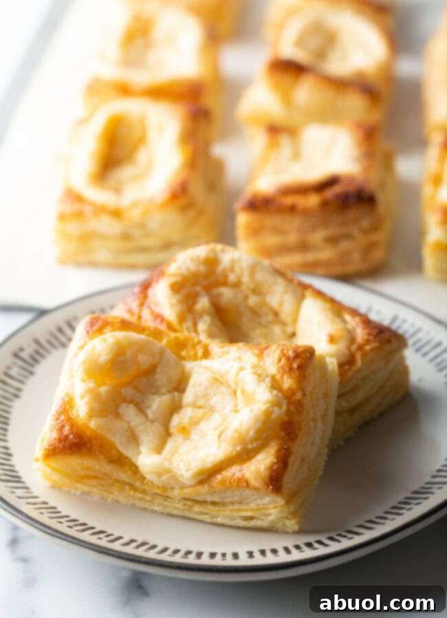 Two large Starbucks style cream cheese danishes on a white plate, ready to be enjoyed.