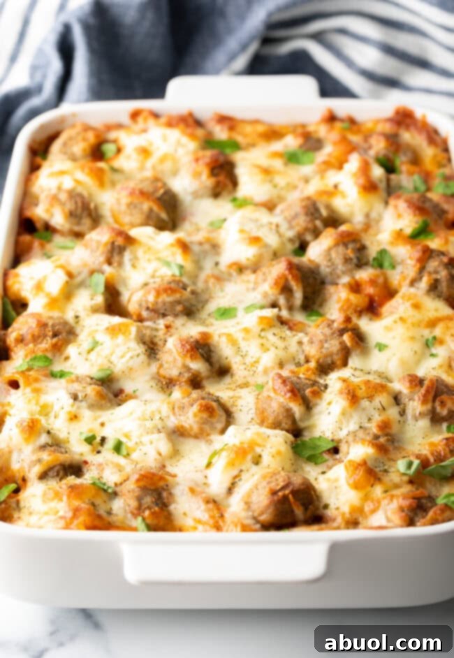 Baked dump and bake meatball casserole in a white dish, bubbly cheese on top.