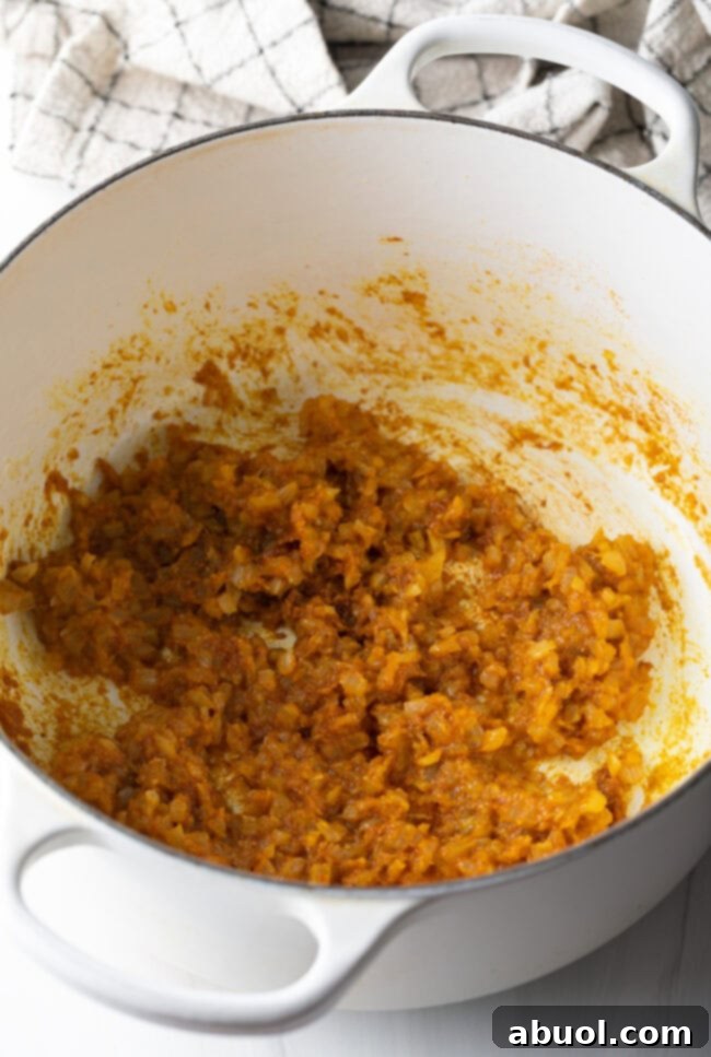 Creamy Lamb Tikka Masala 8 Cooked veggies in a white pot.