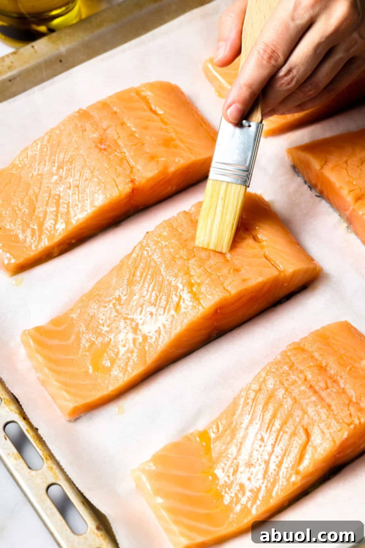 Brushing salmon with oil for roasting