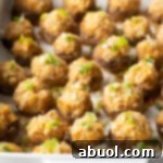 Two dozen seafood stuffed mushrooms in a white baking dish.
