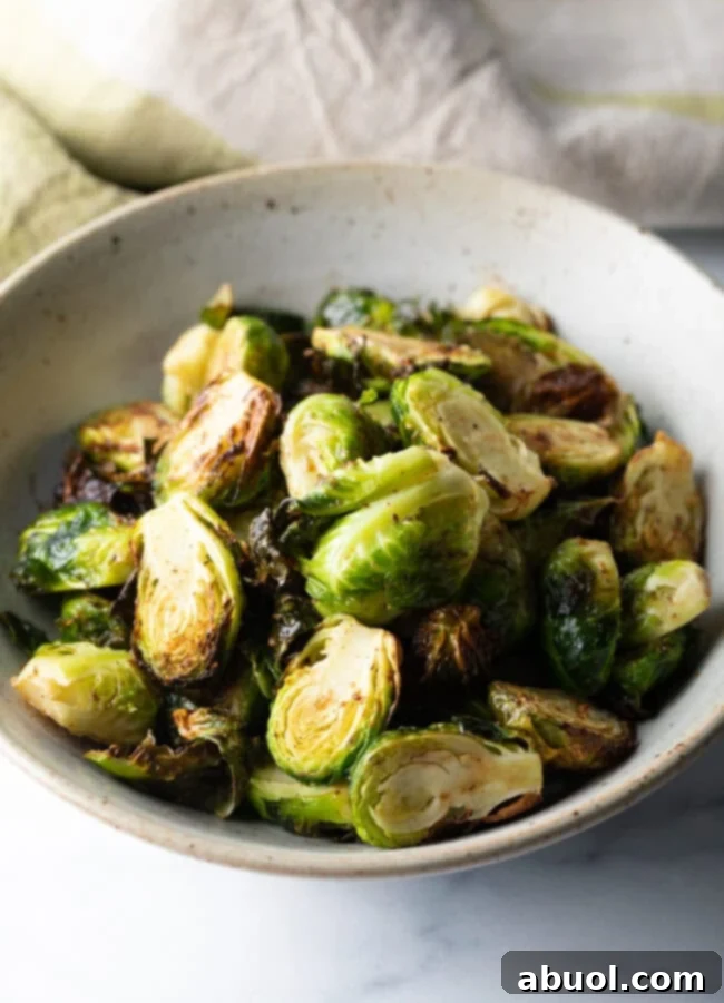 White bowl of crispy air fryer Brussels sprouts.