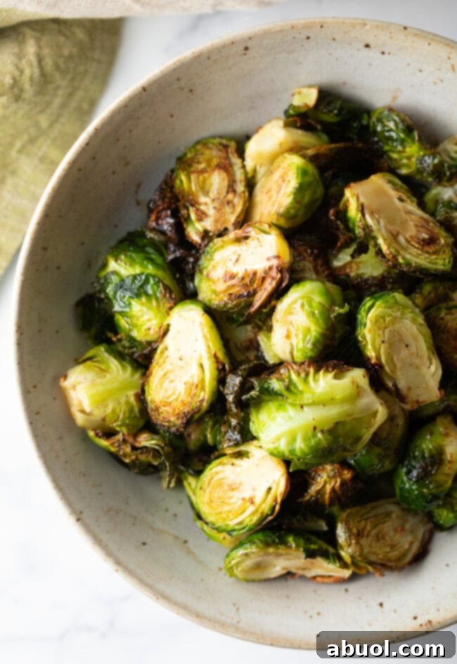 White bowl of crispy air fryer Brussels sprouts.