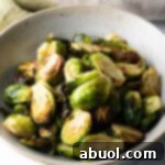 White bowl of crispy air fryer Brussels sprouts.