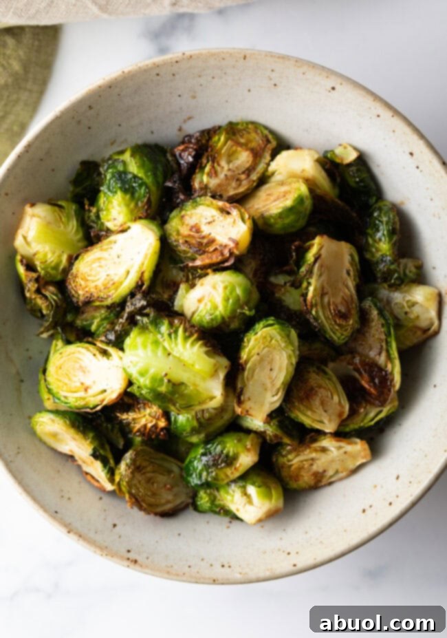 White bowl of crispy air fryer Brussels sprouts.