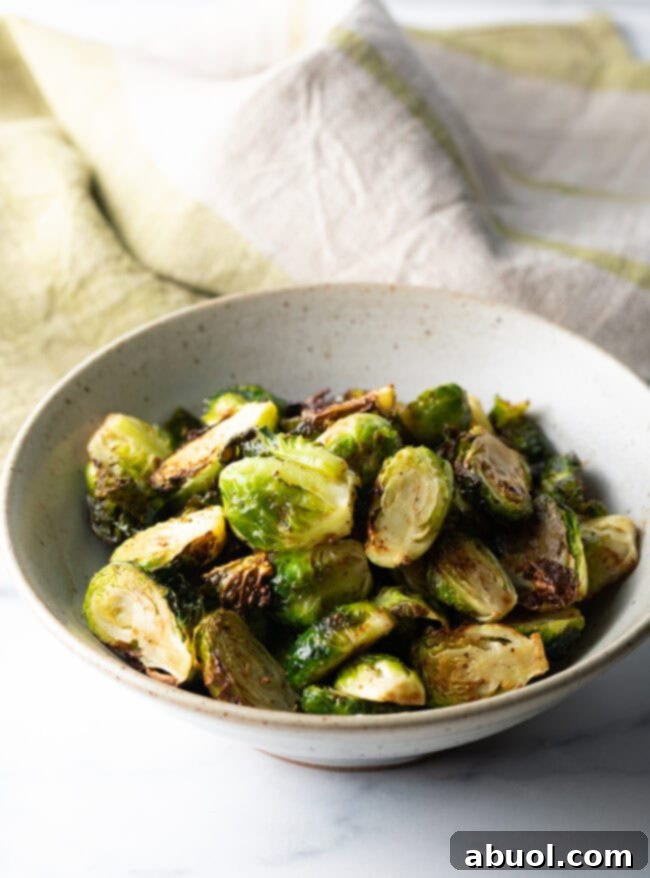 White bowl of crispy air fryer Brussels sprouts.