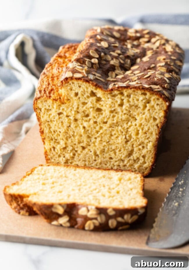 Loaf of cottage cheese bread, one piece sliced to show inside of the loaf.
