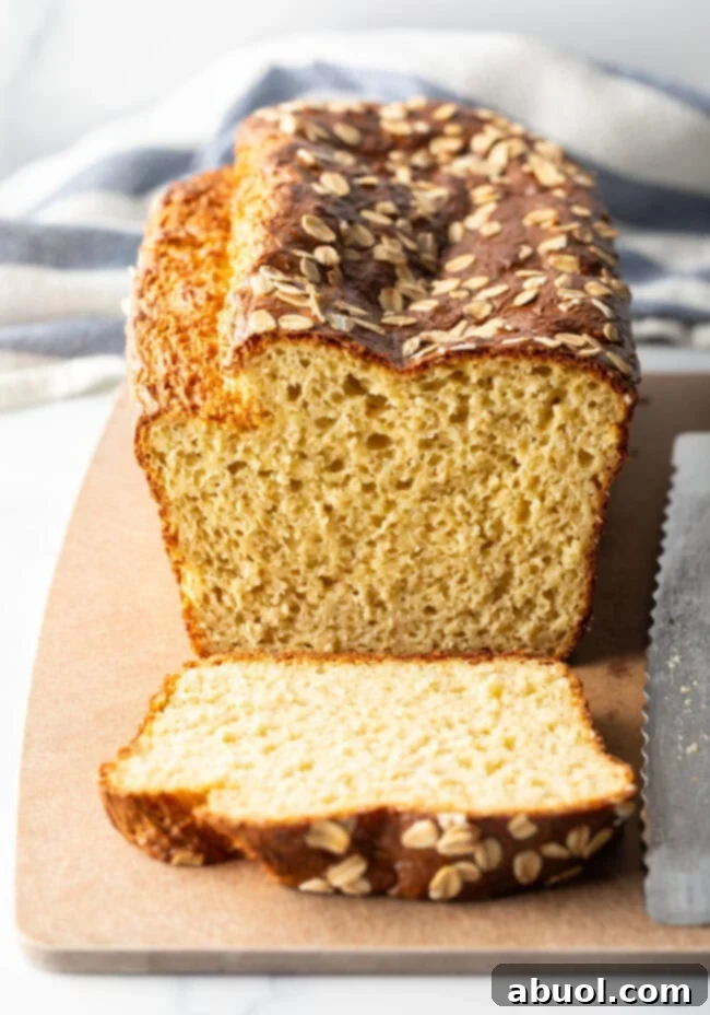 Loaf of high protein cottage cheese bread with one piece sliced to show inside of the loaf.