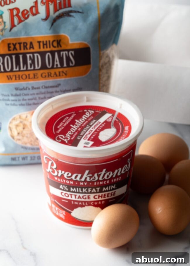 Bread recipe ingredients: Bag of rolled oats, container of cottage cheese, and several eggs.