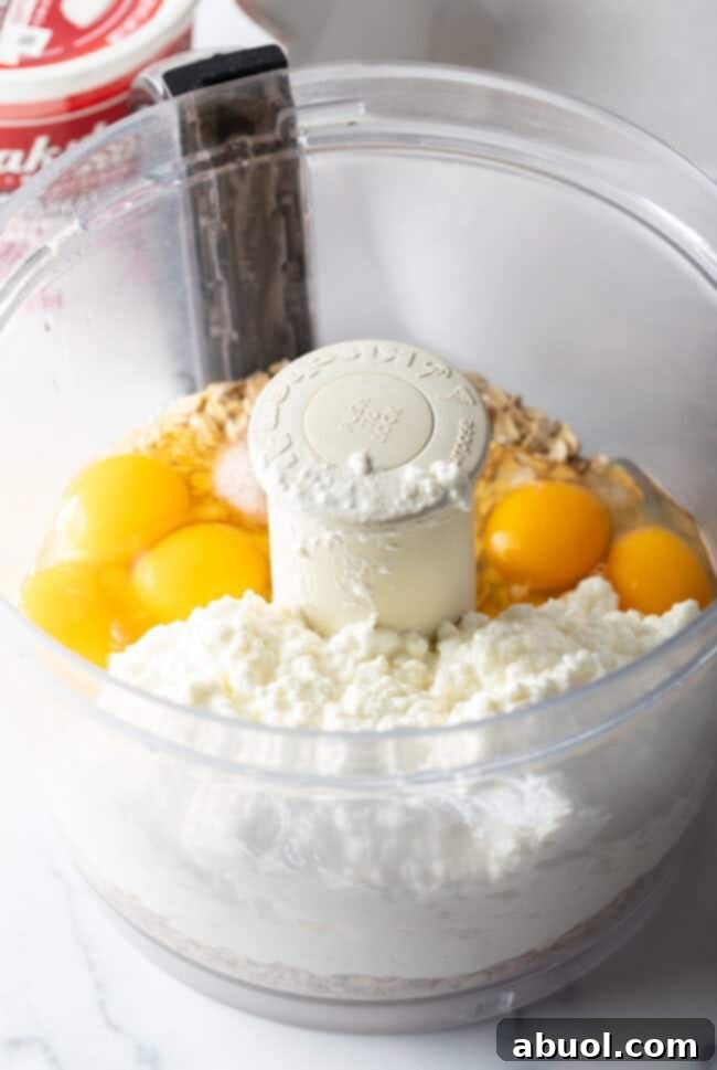 Eggs, cottage cheese, and oats in a food processor.