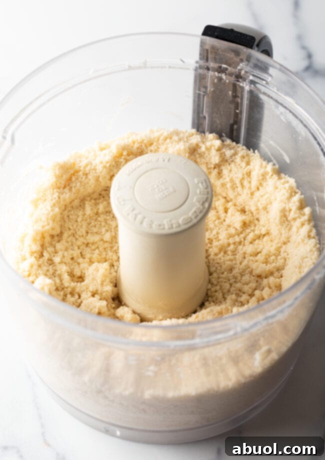 Crumbly pie dough ingredients in a food processor.