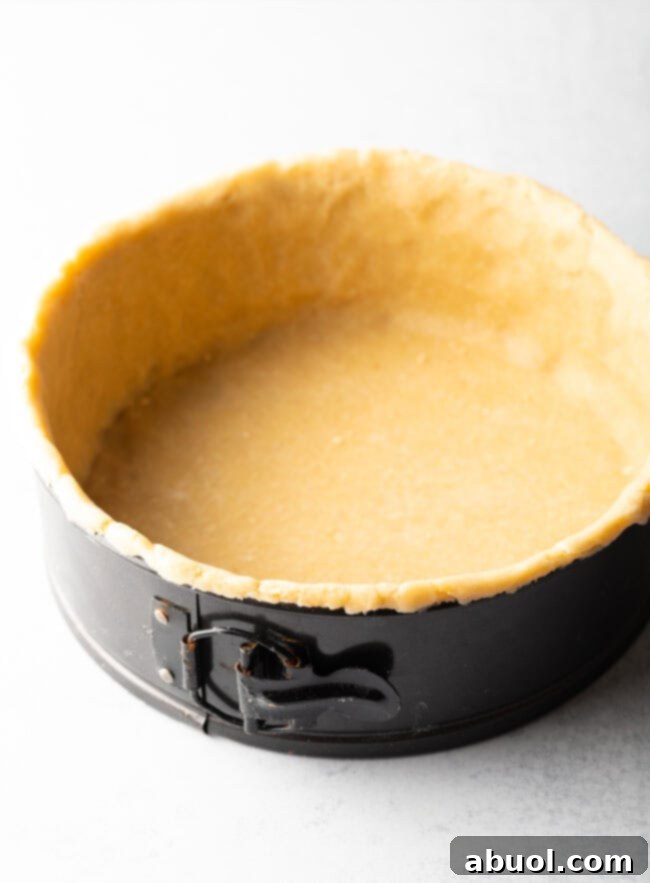 Rustic pie dough lining a deep dish springform pan.