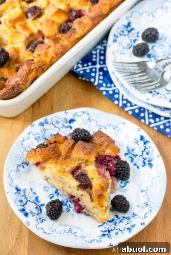 Blackberry bread pudding served on a plate with more in the background. 