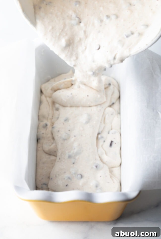 Easy 3-Ingredient Ice Cream Bread 8 Pouring batter into a ceramic loaf pan.