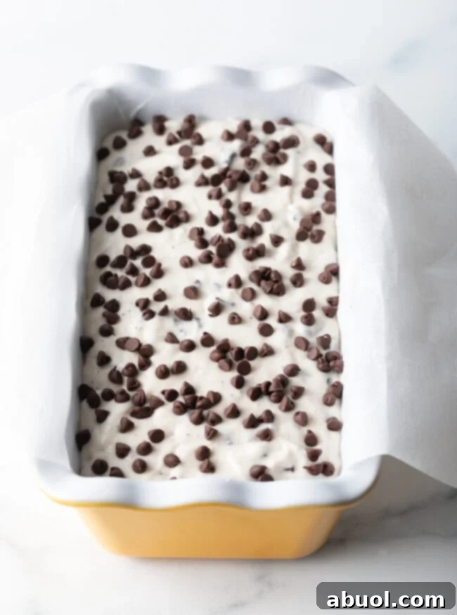 Easy 3-Ingredient Ice Cream Bread 9 Batter in a yellow ceramic baking pan loaf.