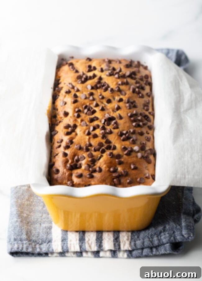 Easy 3-Ingredient Ice Cream Bread 10 Ice cream bread with chocolate chips in a yellow ceramic baking pan loaf.