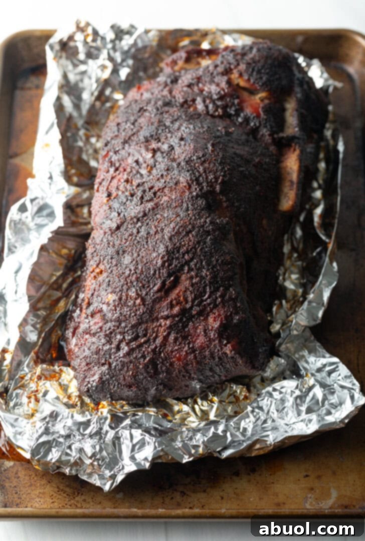 Smoked pork butt unwrapped from aluminum foil.