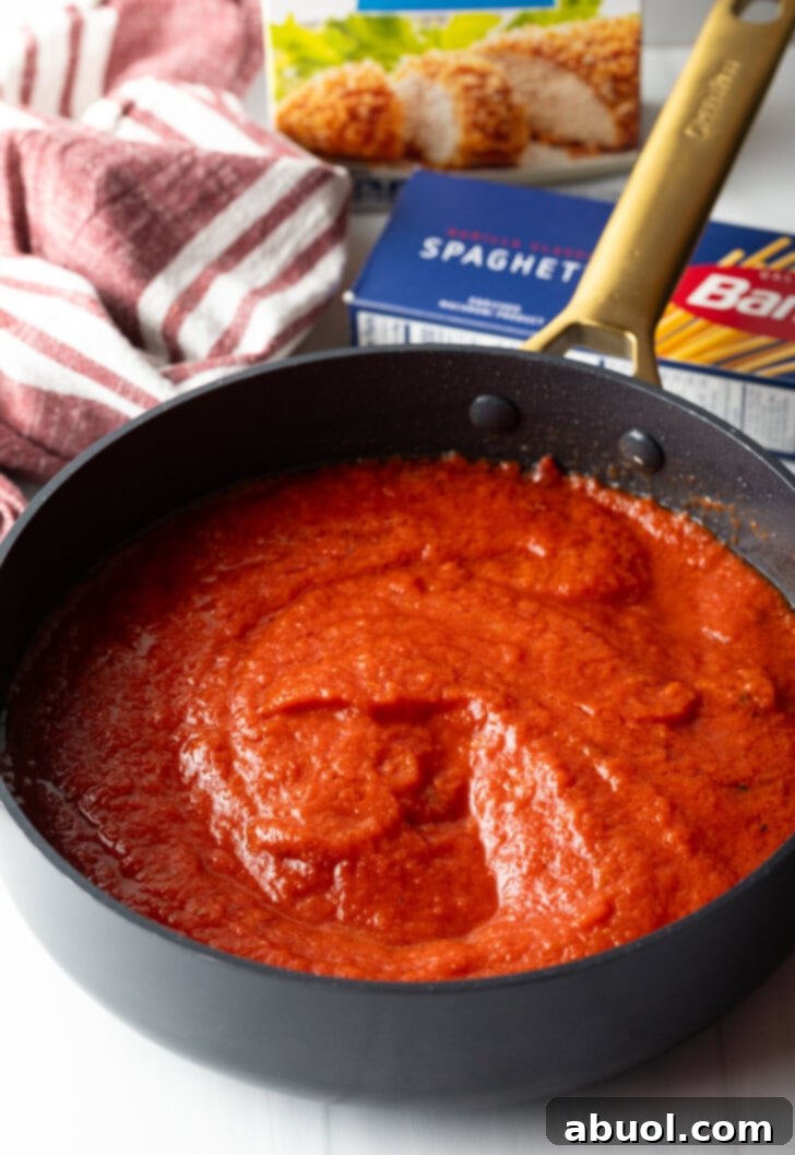 Marinara sauce in a deep black skillet.