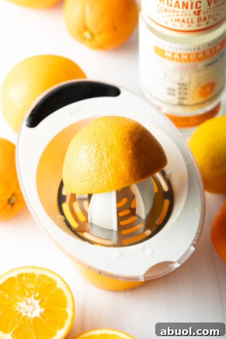Ultimate Orange Crush Cocktail 6 Juicing an orange.