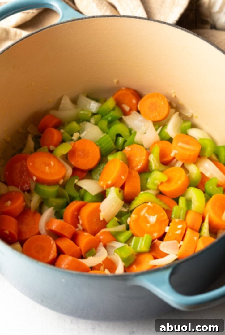 Chopped carrots, celery, and onion in a soup pot.