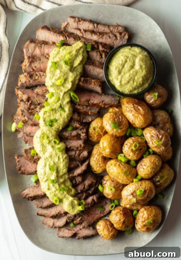 Strips of steak topped with creamy poblano sauce with a side of roasted baby potatoes.